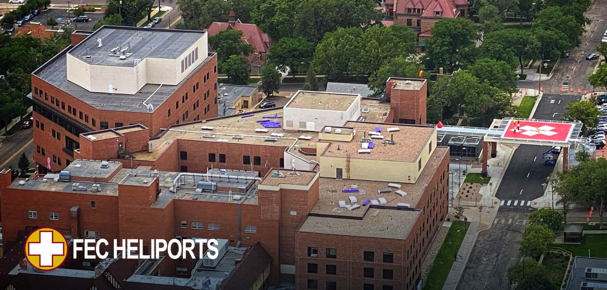 Aerial view of Parkview Hospital in Pueblo, CO, featuring an FEC-designed elevated heliport spanning a public street, providing direct access to the emergency department.