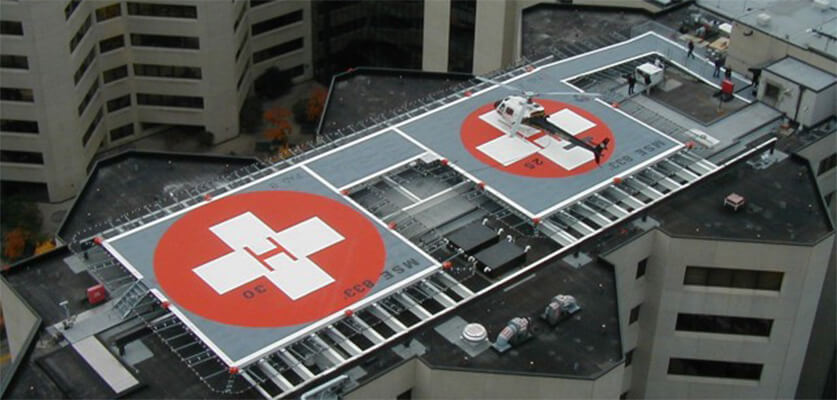 Aerial view of a vertiport with multiple rooftop landing pads designed for VTOL aircraft in an urban environment